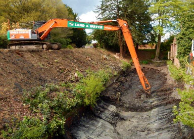 Long reach excavator dredging